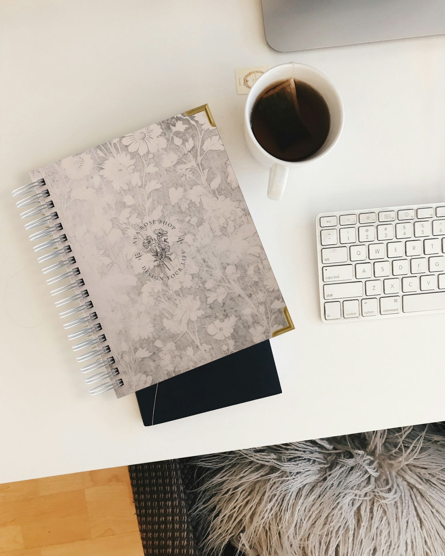 planner, coffee cup, and keyboard on a desk