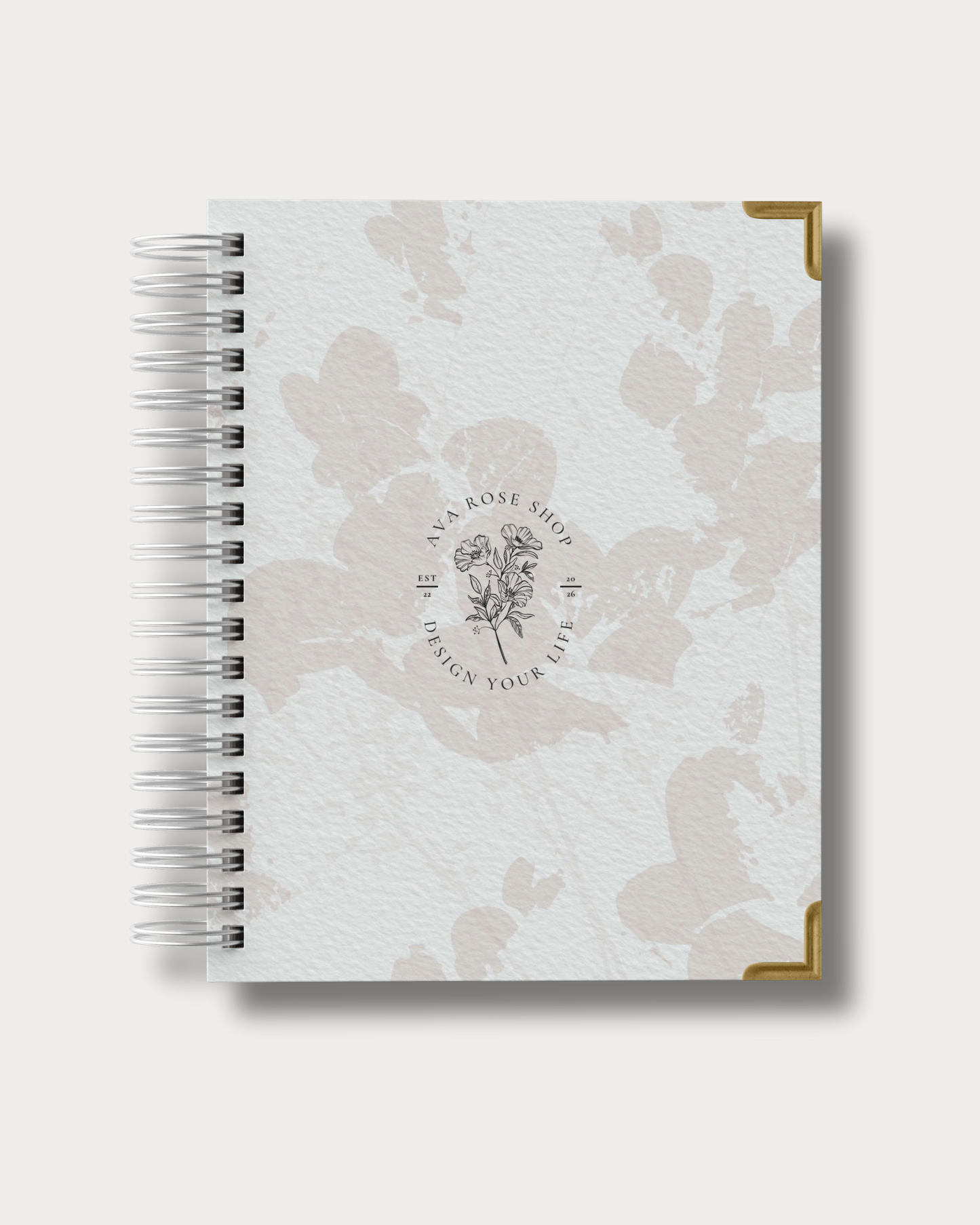 Spiral-bound planner with floral design and brand logo on a white background
